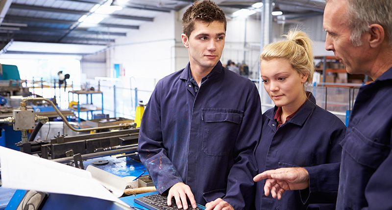 Workers using mobile time and attendance software