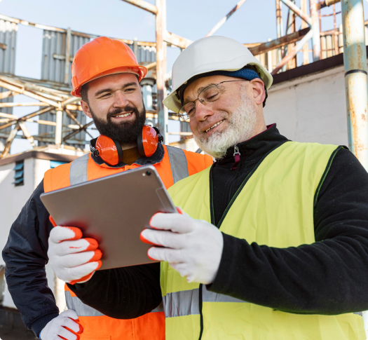 Consturction workers using mobile construction management software on tablet