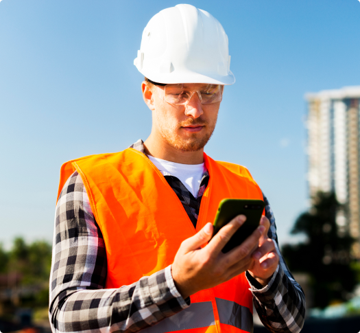 construction worker using data collection software on mobile phone