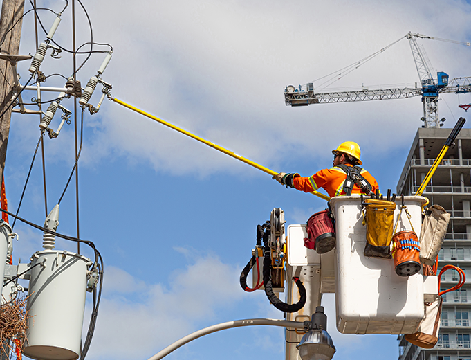 Electrical worker using construction field management software