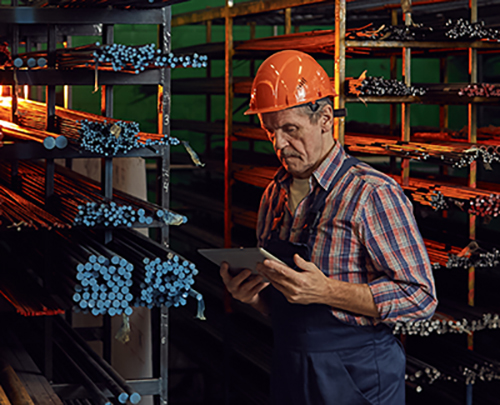 Industrial worker tracking structural steel and piping materials